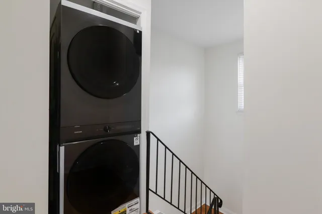 a view of a hallway with washer and dryer