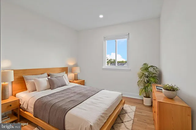 a bedroom with a bed and a potted plant