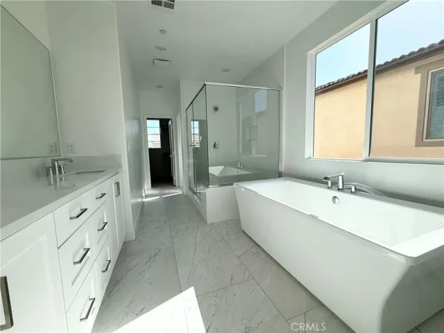 an empty room with a window and a chandelier