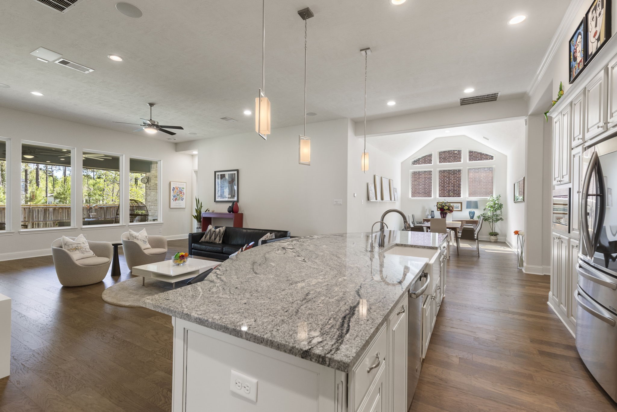 4115 Flagstone Pine Lane Spring, TX 77386 - Photo 12 of 40 The kitchen seamlessly opens to the family room, creating a warm and inviting space that allows the cook to stay connected with family and guests while preparing meals. This open-concept design fosters effortless interaction and makes entertaining both enjoyable and convenient.