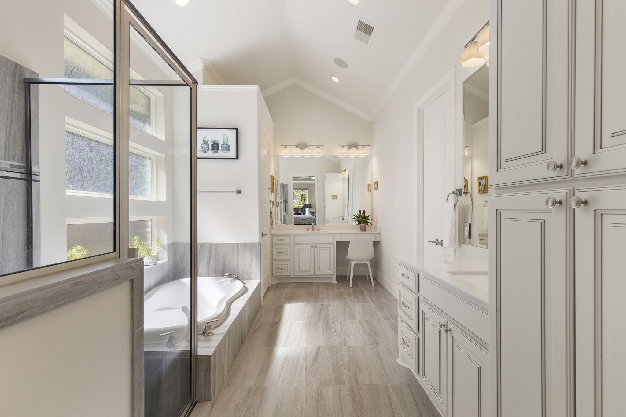 4115 Flagstone Pine Lane Spring, TX 77386 - Photo 16 of 40 The ensuite primary bathroom is a luxurious haven, featuring dual sink areas for added convenience and an oversized walk-in shower that exudes spa-like elegance.