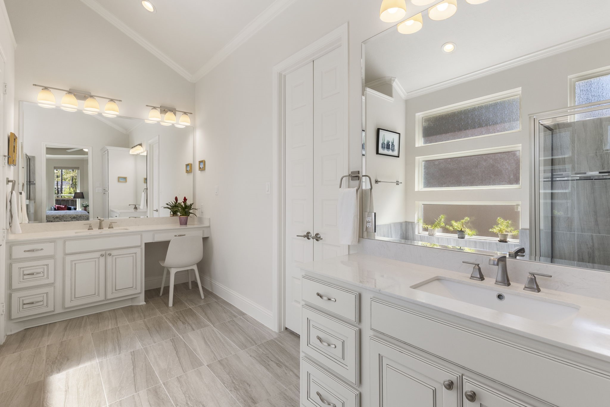 4115 Flagstone Pine Lane Spring, TX 77386 - Photo 17 of 40 The vanity area is a delightful addition, providing a dedicated space for your daily routine. The oversized walk-in closet is equally impressive, offering abundant storage and a thoughtfully designed built-in closet system to keep everything organized and easily accessible. With ample room and smart functionality, this space is both practical and luxurious.