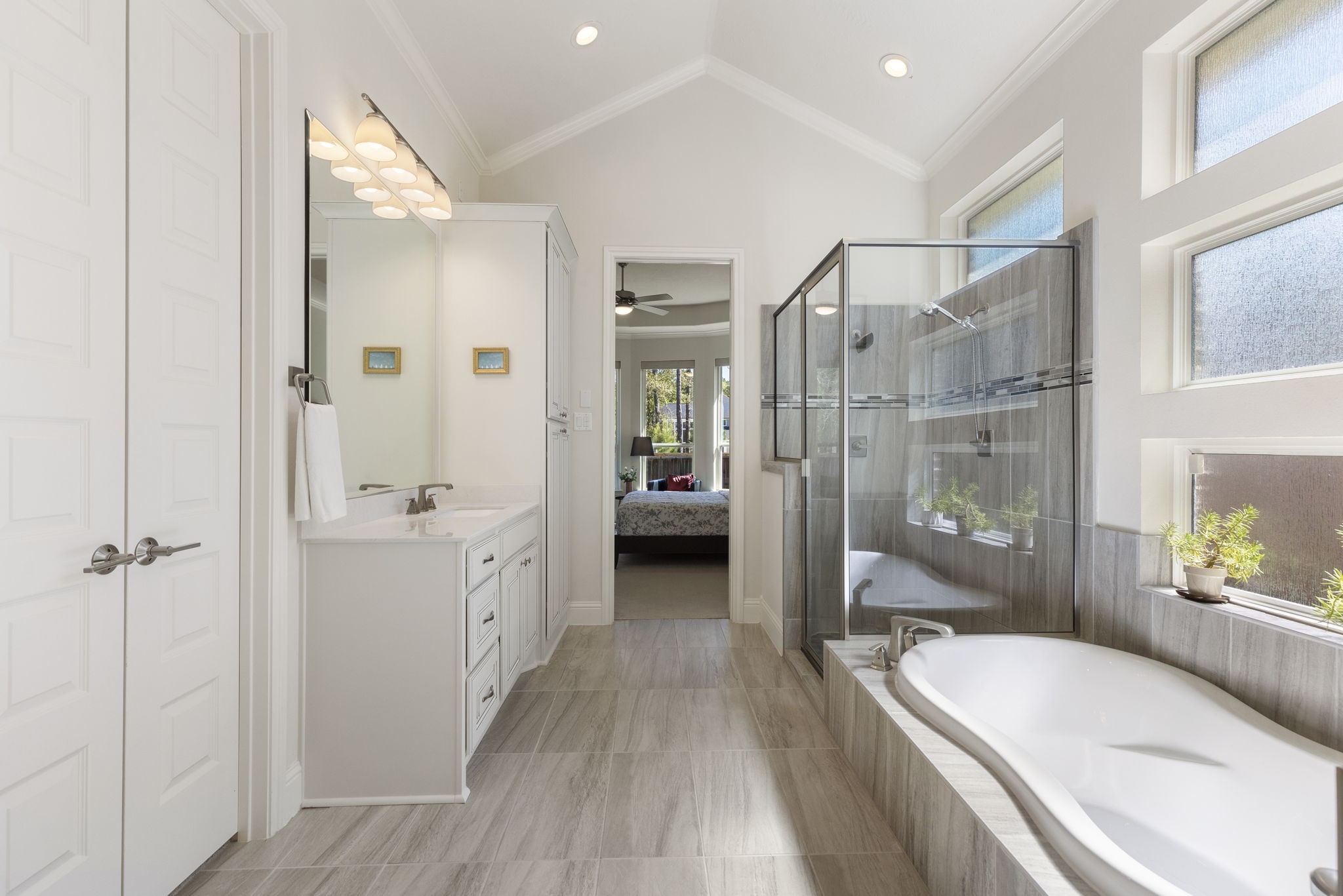 4115 Flagstone Pine Lane Spring, TX 77386 - Photo 18 of 40 The oversized soaking tub is a true centerpiece, offering the perfect spot to unwind at the end of the day. Its deep, inviting design is ideal for relaxing with a good book, creating a spa-like experience in the comfort of your own home.