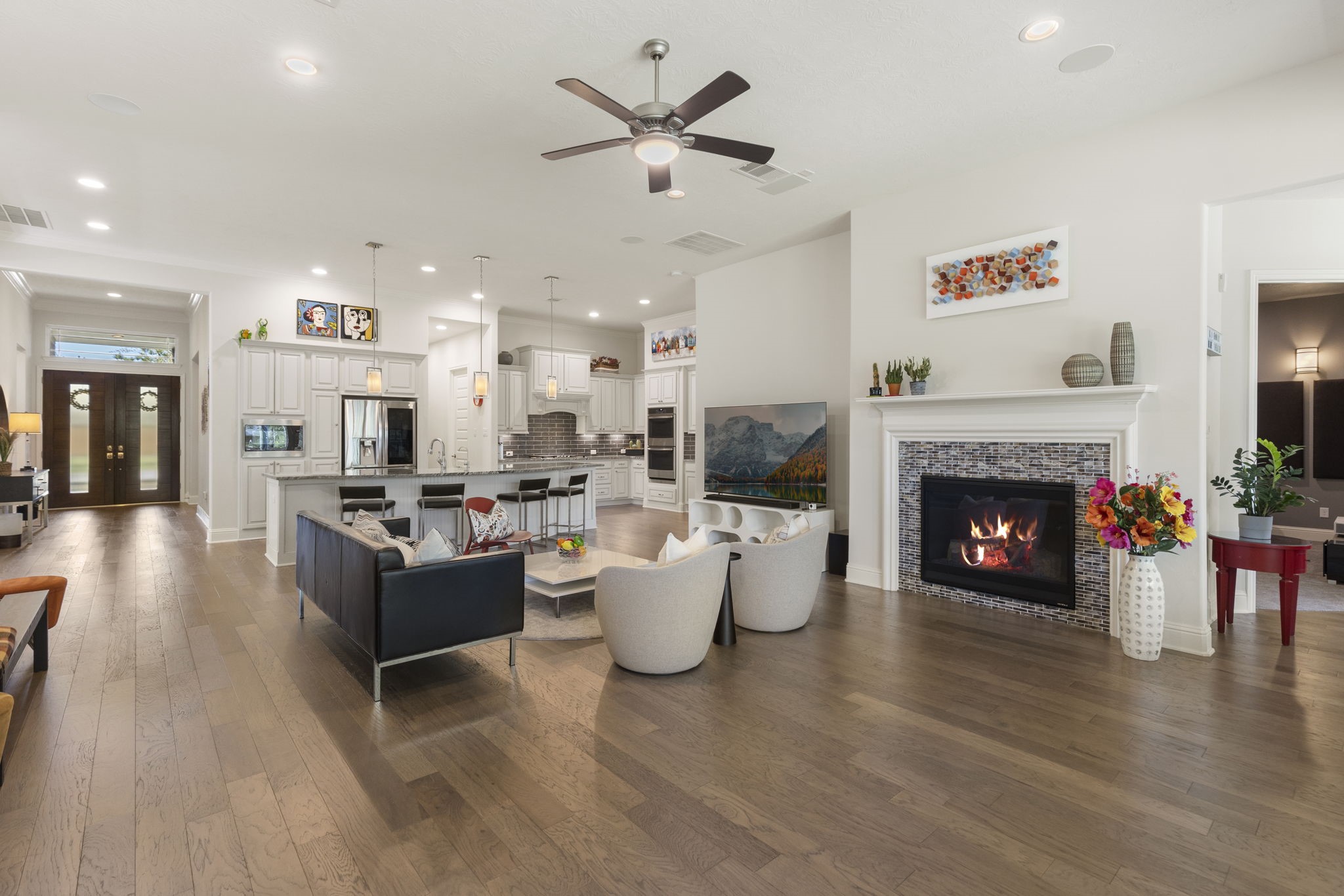 4115 Flagstone Pine Lane Spring, TX 77386 - Photo 3 of 40 The heart of the home features spacious living areas that flow seamlessly, creating an inviting atmosphere for gatherings or quiet evenings. The open design allows for effortless interaction between the kitchen, dining, and living spaces, making it perfect for creating lasting memories.