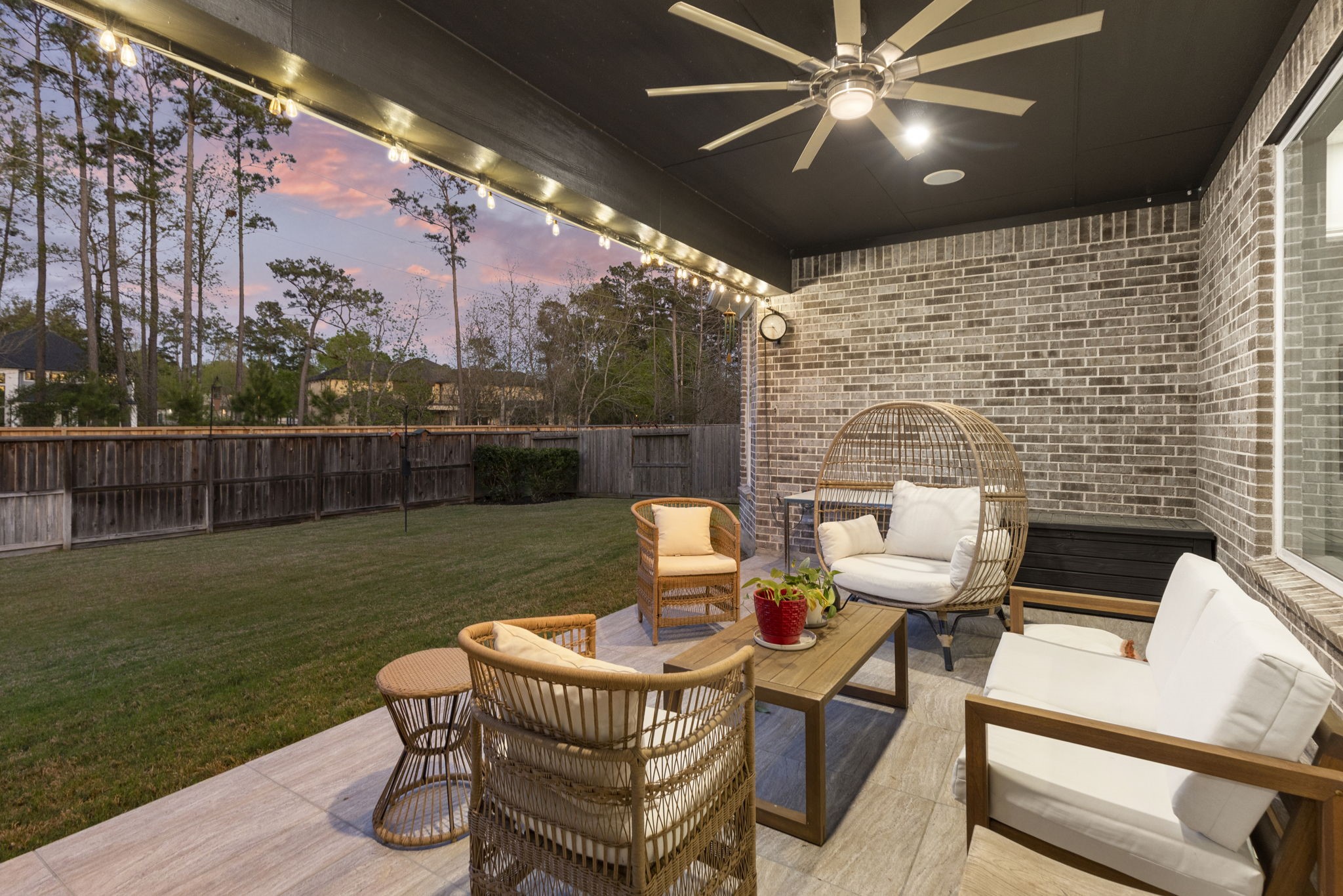 4115 Flagstone Pine Lane Spring, TX 77386 - Photo 31 of 40 Start your day by grabbing a cup of coffee and settling into the inviting covered back patio. This serene space is perfect for enjoying your favorite book while soaking in the peaceful ambiance of the outdoors, offering a tranquil retreat rain or shine.