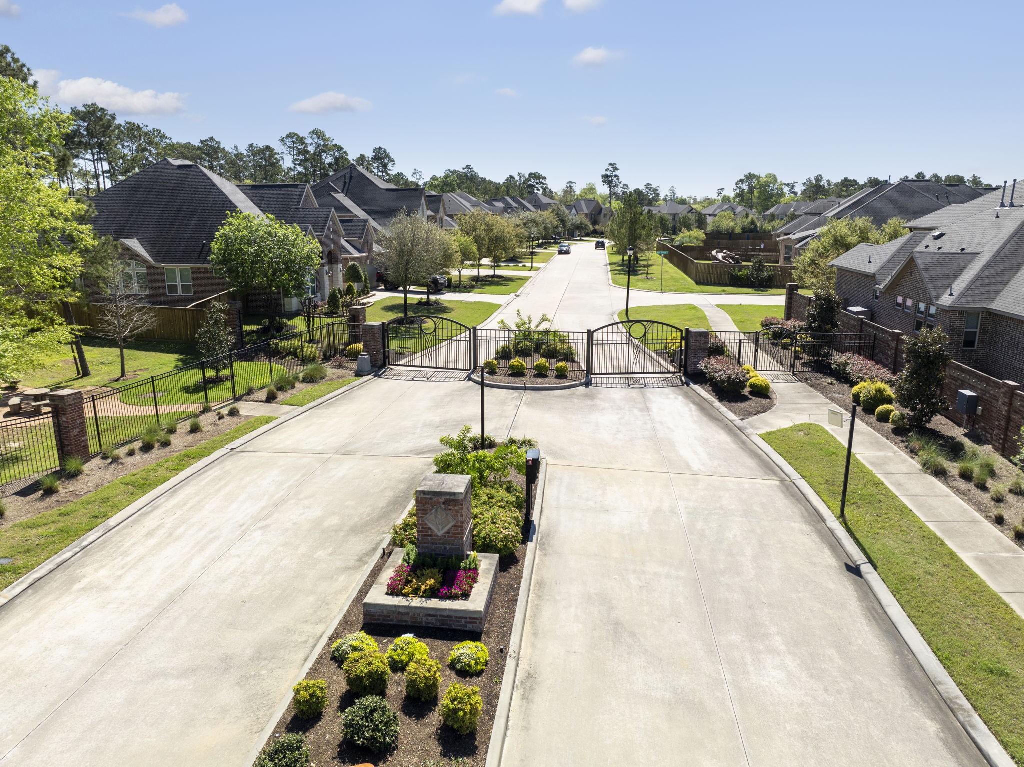 4115 Flagstone Pine Lane Spring, TX 77386 - Photo 36 of 40 This picturesque enclave of homes is set behind an access gate, providing an added sense of privacy and exclusivity. The gated entry creates a peaceful and secluded environment, offering residents a serene retreat from the outside world while fostering a close-knit community feel.