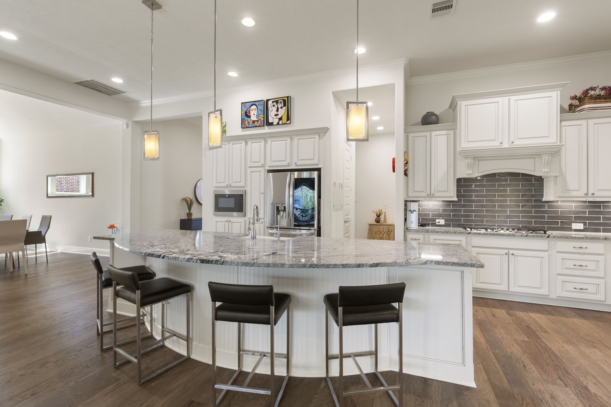 4115 Flagstone Pine Lane Spring, TX 77386 - Photo 8 of 40 The eat-in breakfast bar area serves as the heart of the home in the mornings, offering a cozy and convenient space where family members can gather to share a meal and discuss the day's plans. Its inviting design makes it the perfect spot to connect and start the day on a positive note before heading out for a busy schedule.