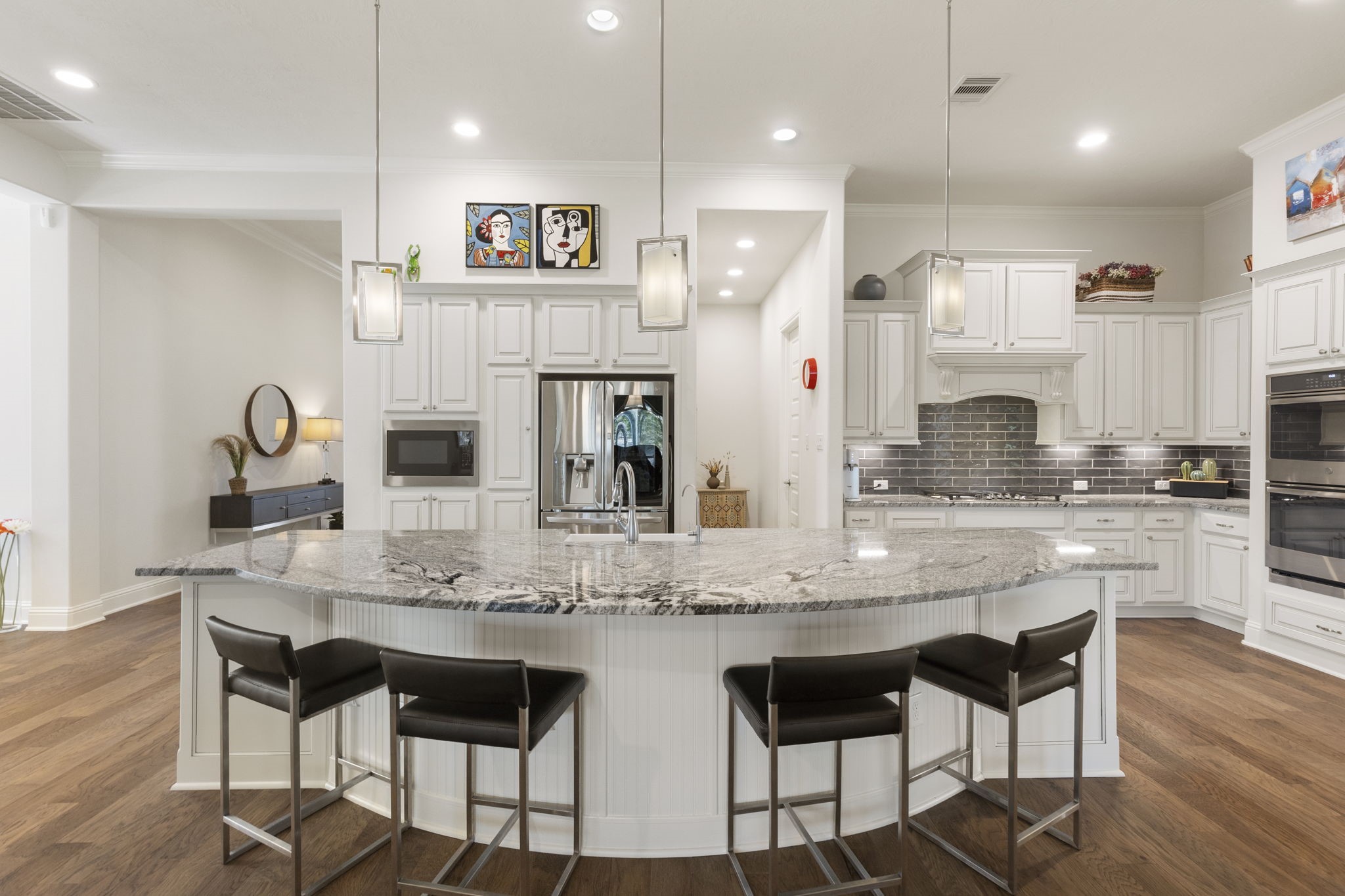 4115 Flagstone Pine Lane Spring, TX 77386 - Photo 9 of 40 This kitchen is equipped with top-of-the-line features, including sleek double ovens, a high-performance gas cooktop, a built-in microwave, and so much more. Every detail has been thoughtfully designed to enhance functionality and elevate your cooking experience, making it a true haven for culinary enthusiasts.