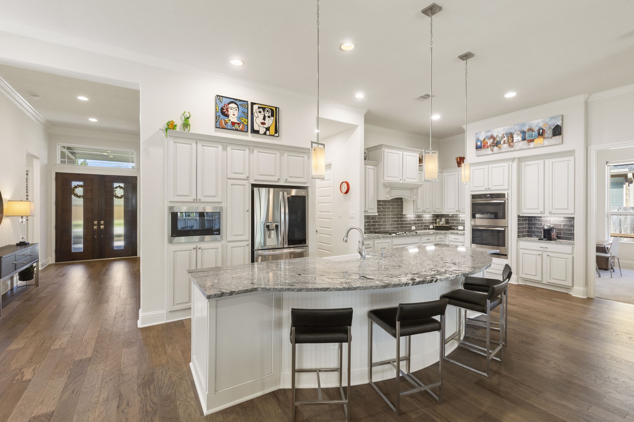 4115 Flagstone Pine Lane Spring, TX 77386 - Photo 10 of 40 A cook's delight, this island kitchen is a masterpiece of both style and functionality. The expansive island provides ample workspace, perfect for whipping up delicious dinners or tackling creative culinary projects. With its thoughtful layout, high-end appliances, and abundant storage, this kitchen is designed to inspire and cater to every chef's needs, whether preparing a casual meal or hosting a gourmet feast.