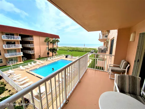 a view of a balcony with furniture