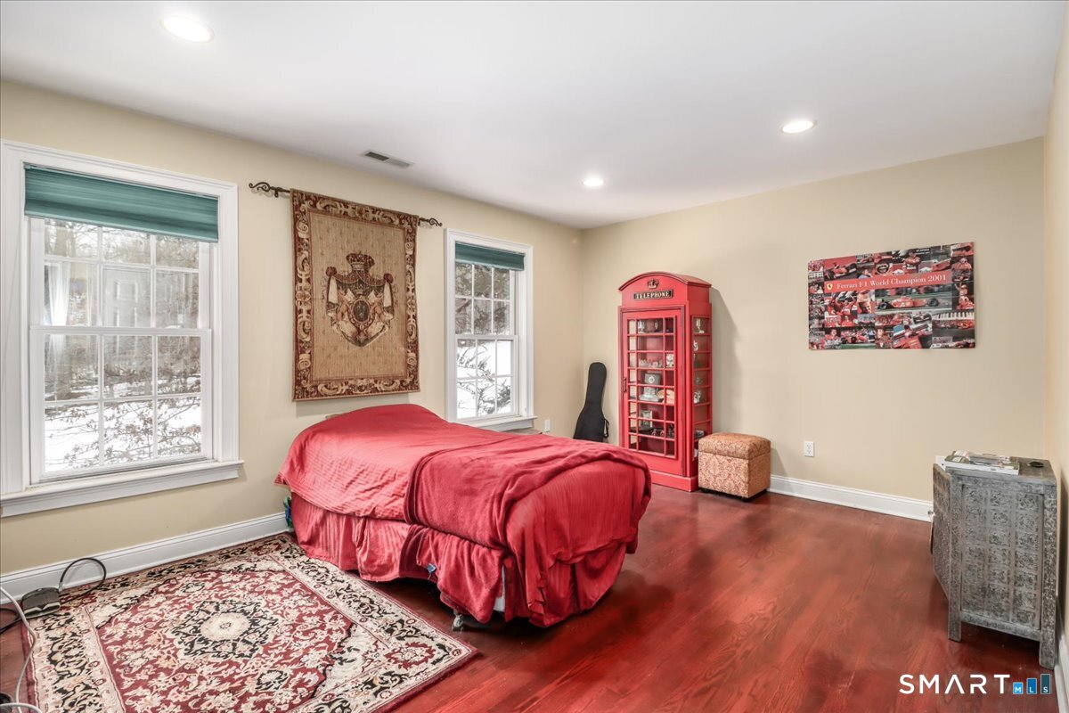 80 Maple Road Easton, CT 06612 - Photo 24 of 37 a bedroom with a bed and wooden floor