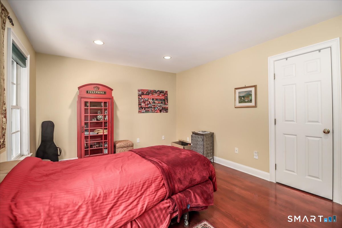 80 Maple Road Easton, CT 06612 - Photo 25 of 37 a bedroom with a bed and a dresser with wooden floor