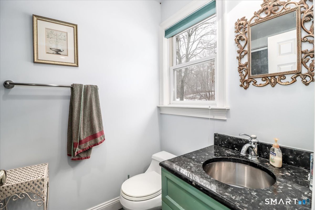 80 Maple Road Easton, CT 06612 - Photo 29 of 37 a bathroom with a sink a toilet and a window