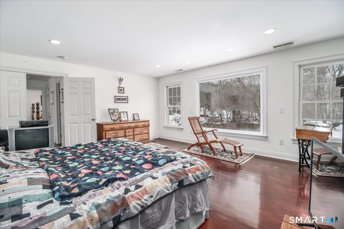 80 Maple Road Easton, CT 06612 - Photo 30 of 37 a bedroom with a bed a table and chair