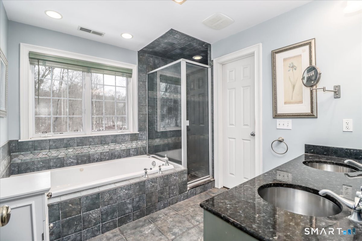 80 Maple Road Easton, CT 06612 - Photo 32 of 37 a bathroom with a granite countertop tub a sink and a large window