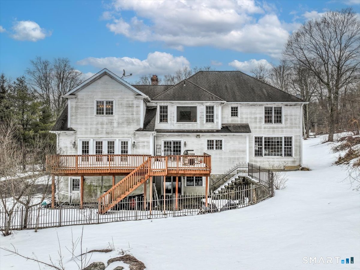 80 Maple Road Easton, CT 06612 - Photo 5 of 37 a view of a house with wooden deck and furniture
