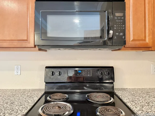 a kitchen with a stove and a microwave