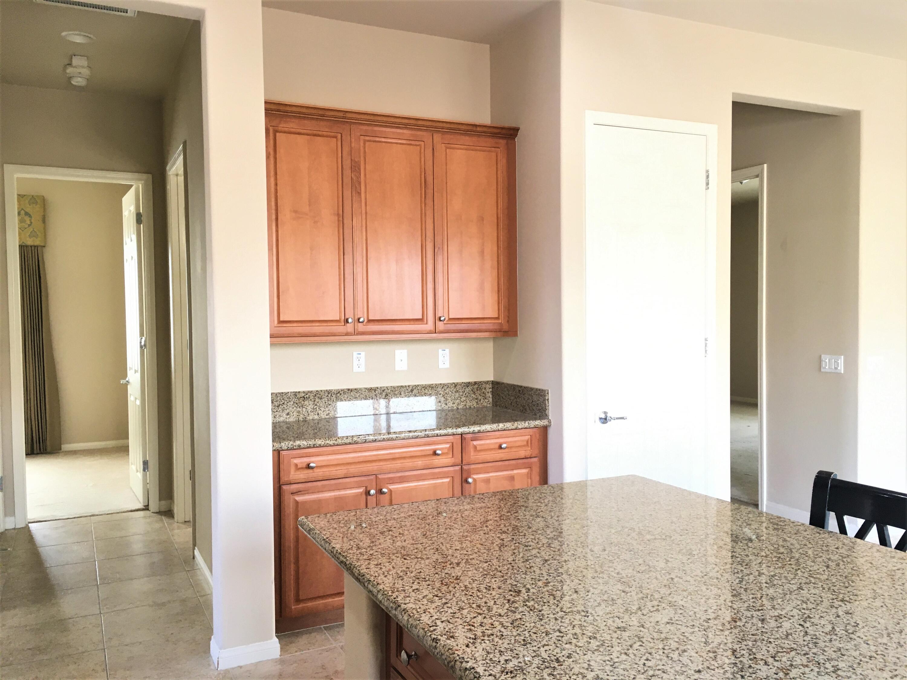 39929 Corte De Moda Indio, CA 92203 - Photo 11 of 46 a kitchen with granite countertop a sink and a refrigerator