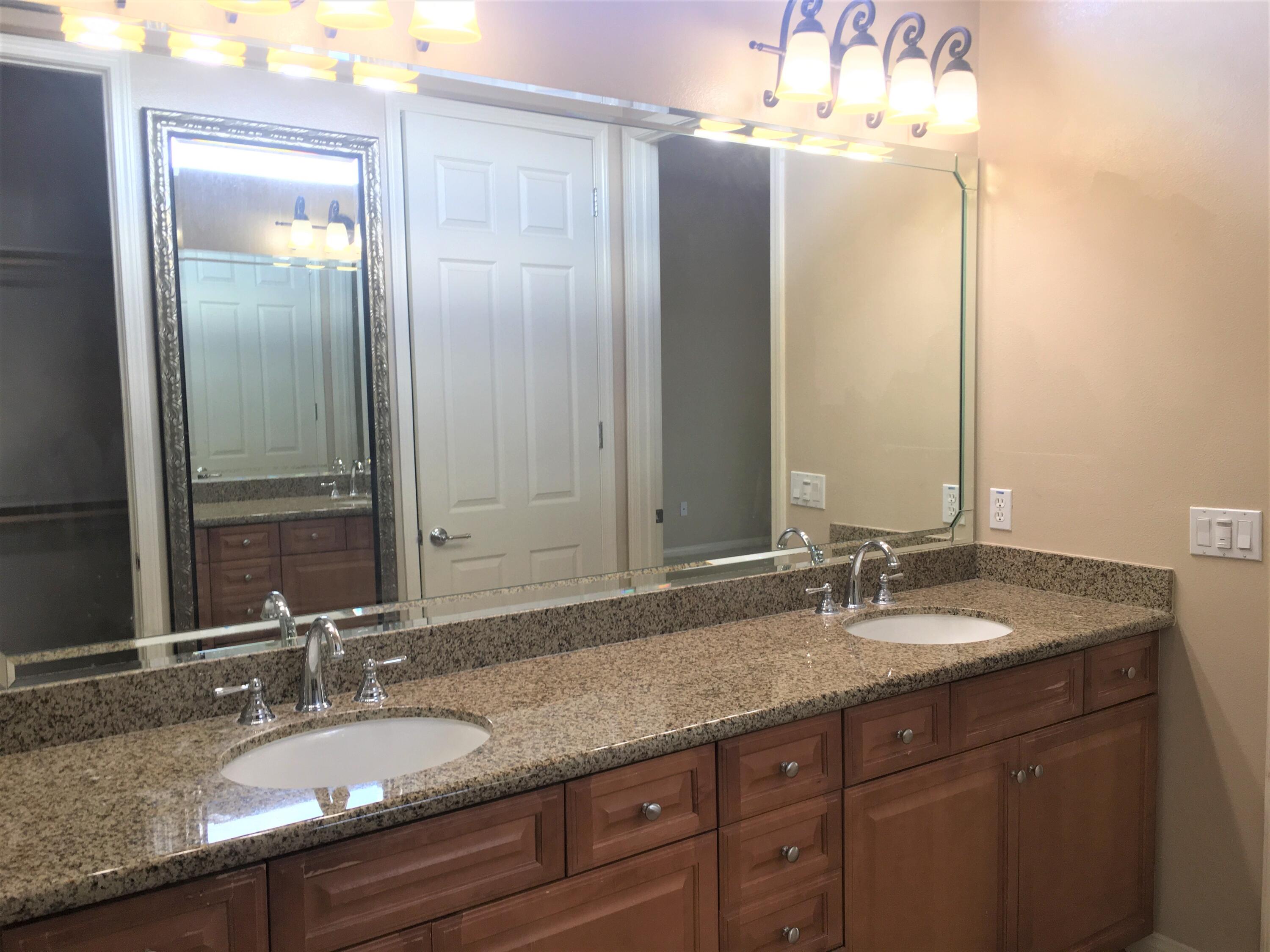 39929 Corte De Moda Indio, CA 92203 - Photo 14 of 46 a bathroom with a granite countertop double vanity sink and a mirror