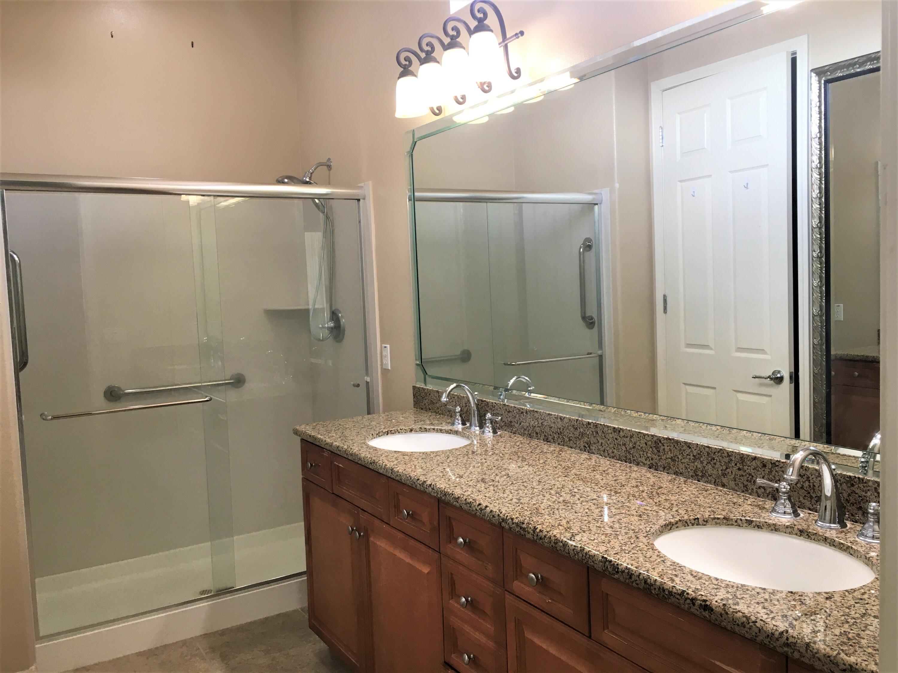 39929 Corte De Moda Indio, CA 92203 - Photo 15 of 46 a bathroom with a granite countertop shower sink and mirror