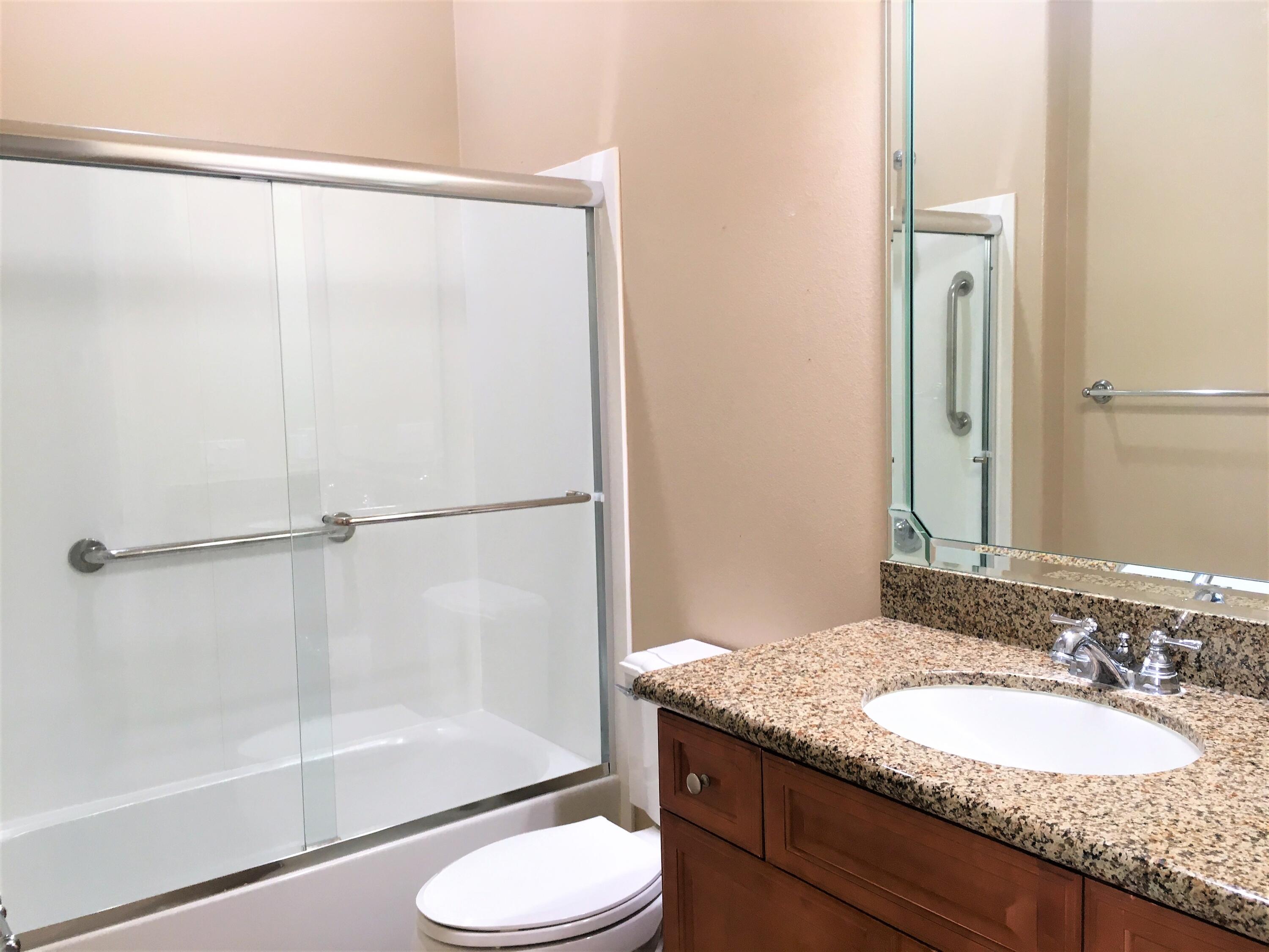 39929 Corte De Moda Indio, CA 92203 - Photo 16 of 46 a bathroom with a granite countertop shower sink and toilet