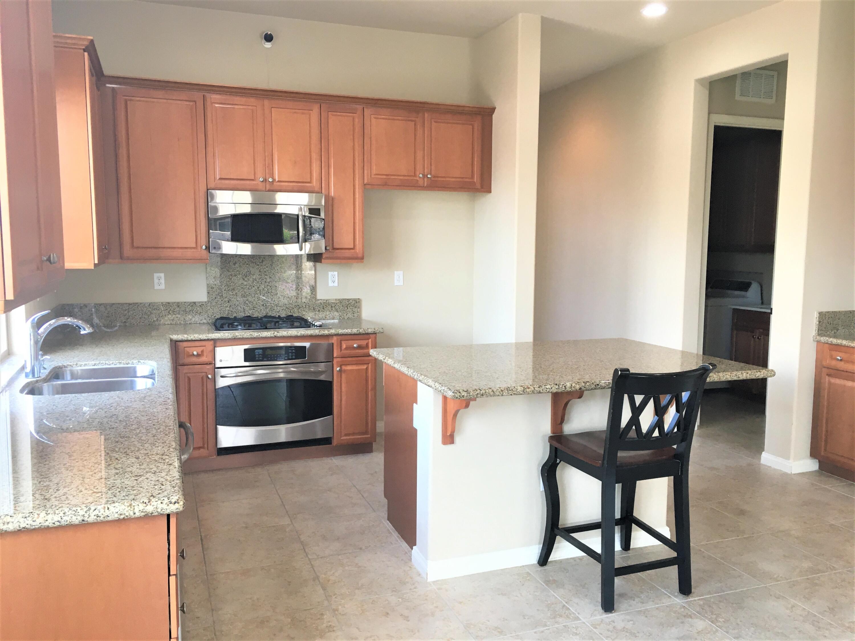 39929 Corte De Moda Indio, CA 92203 - Photo 2 of 46 a kitchen with stainless steel appliances granite countertop a stove a sink and a microwave