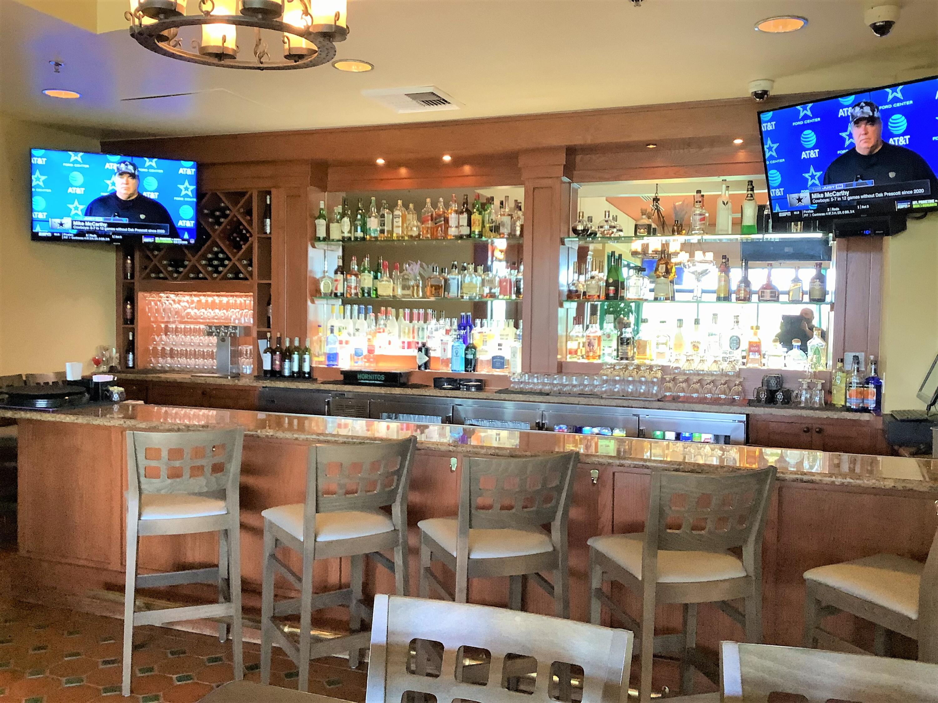 39929 Corte De Moda Indio, CA 92203 - Photo 32 of 46 a kitchen with a table chairs and flat screen tv