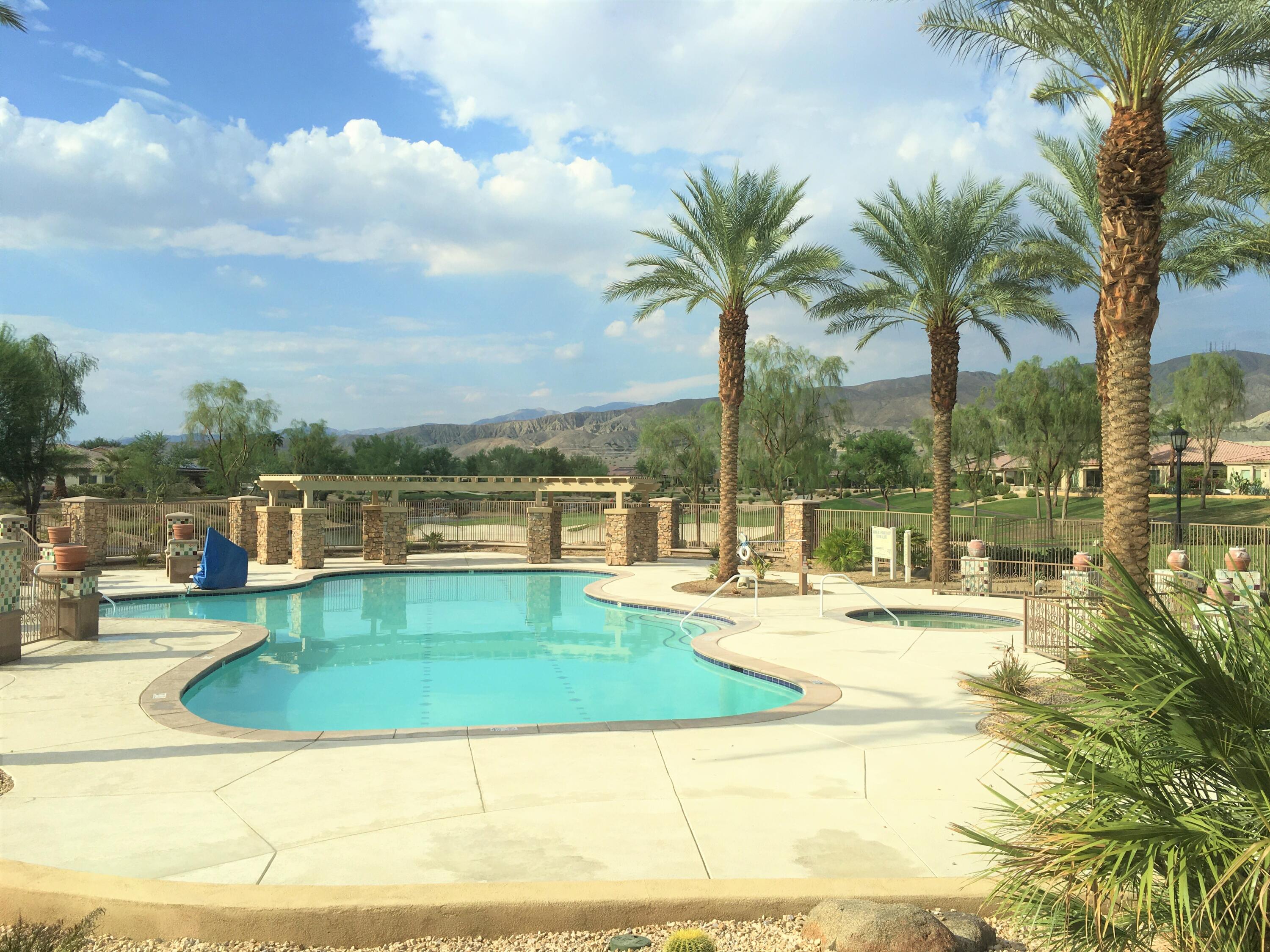 39929 Corte De Moda Indio, CA 92203 - Photo 43 of 46 a view of a swimming pool with a lawn chairs