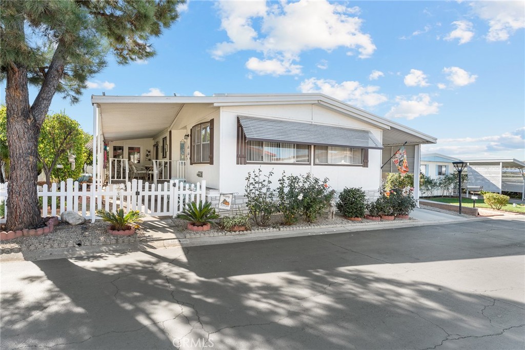 35218 Fir Avenue, Unit 183 Yucaipa, CA 92399 - Photo 1 of 35 a front view of a house with a yard