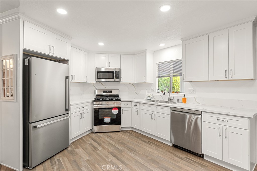 35218 Fir Avenue, Unit 183 Yucaipa, CA 92399 - Photo 12 of 35 a kitchen with white cabinets and white appliances