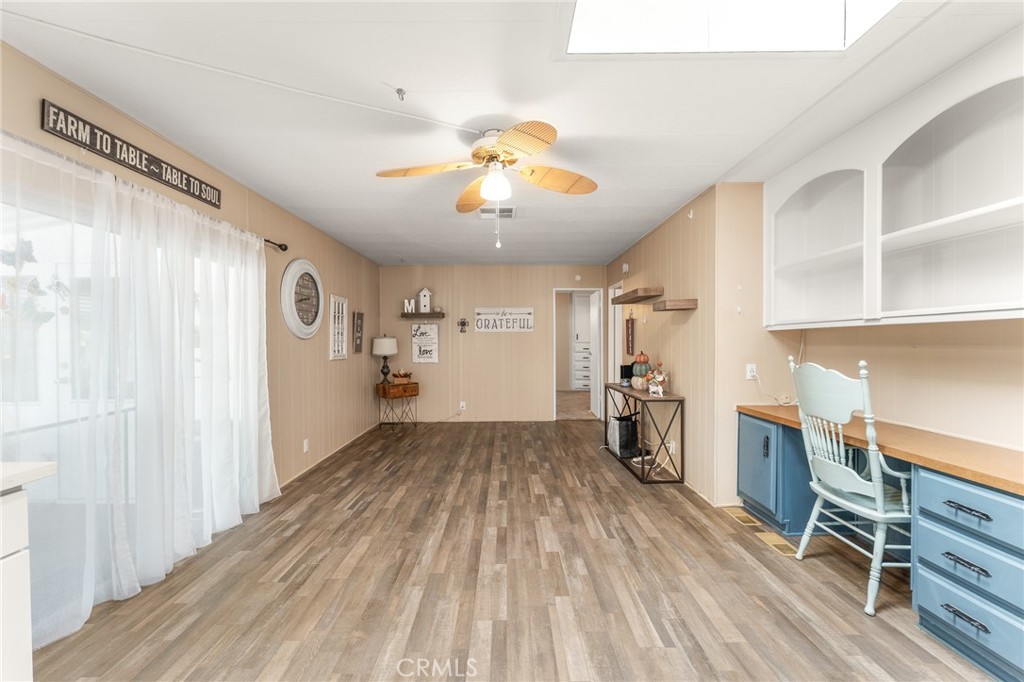35218 Fir Avenue, Unit 183 Yucaipa, CA 92399 - Photo 16 of 35 a view of a workspace with wooden floor and a window