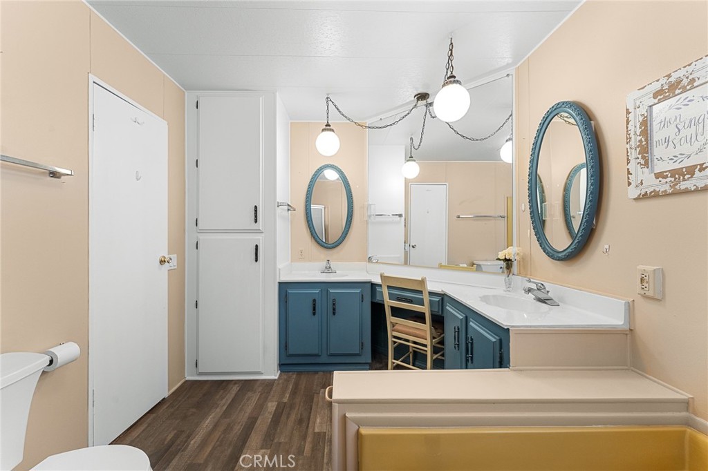 35218 Fir Avenue, Unit 183 Yucaipa, CA 92399 - Photo 20 of 35 a bathroom with a sink a mirror a toilet and a mirror