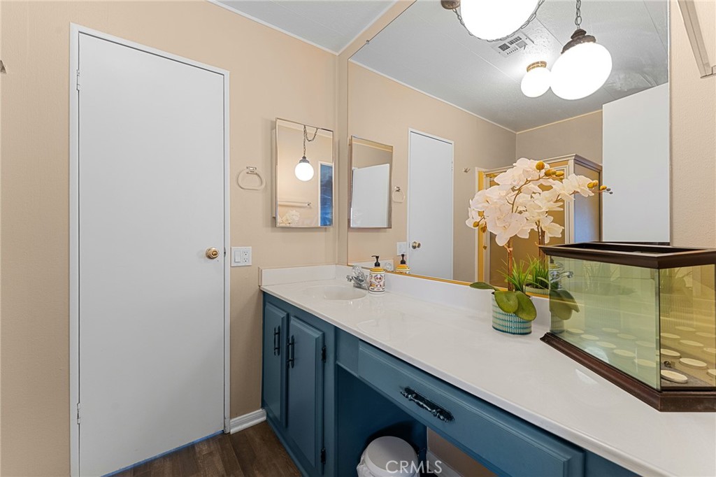 35218 Fir Avenue, Unit 183 Yucaipa, CA 92399 - Photo 23 of 35 a bathroom with a sink and a mirror