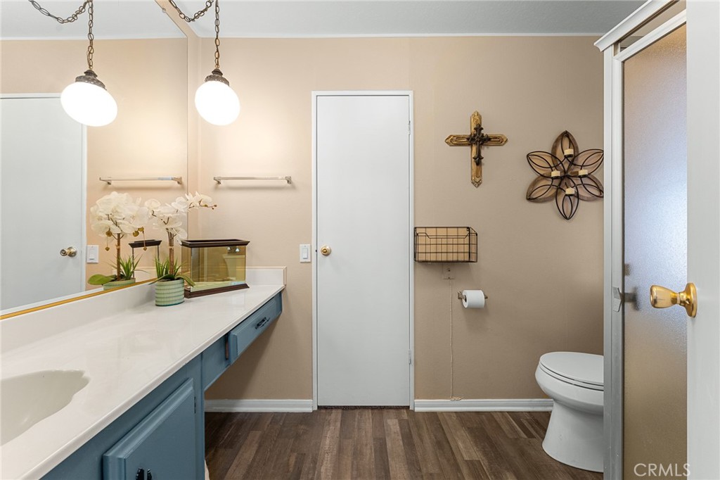 35218 Fir Avenue, Unit 183 Yucaipa, CA 92399 - Photo 24 of 35 a bathroom with a sink a toilet and mirror