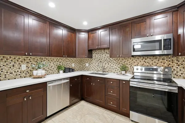 a kitchen with sink cabinets and stainless steel appliances
