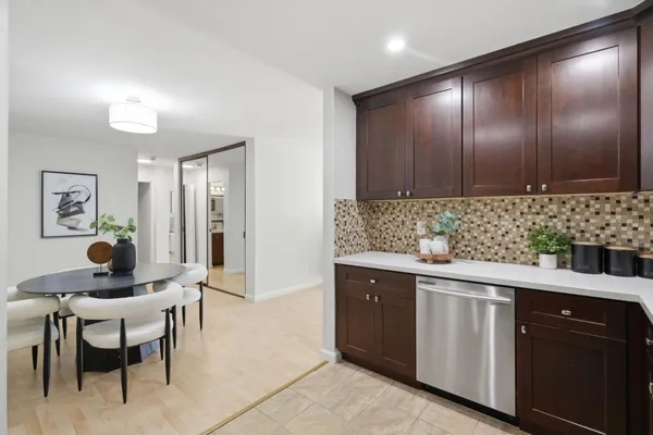 a kitchen with granite countertop a sink and cabinets