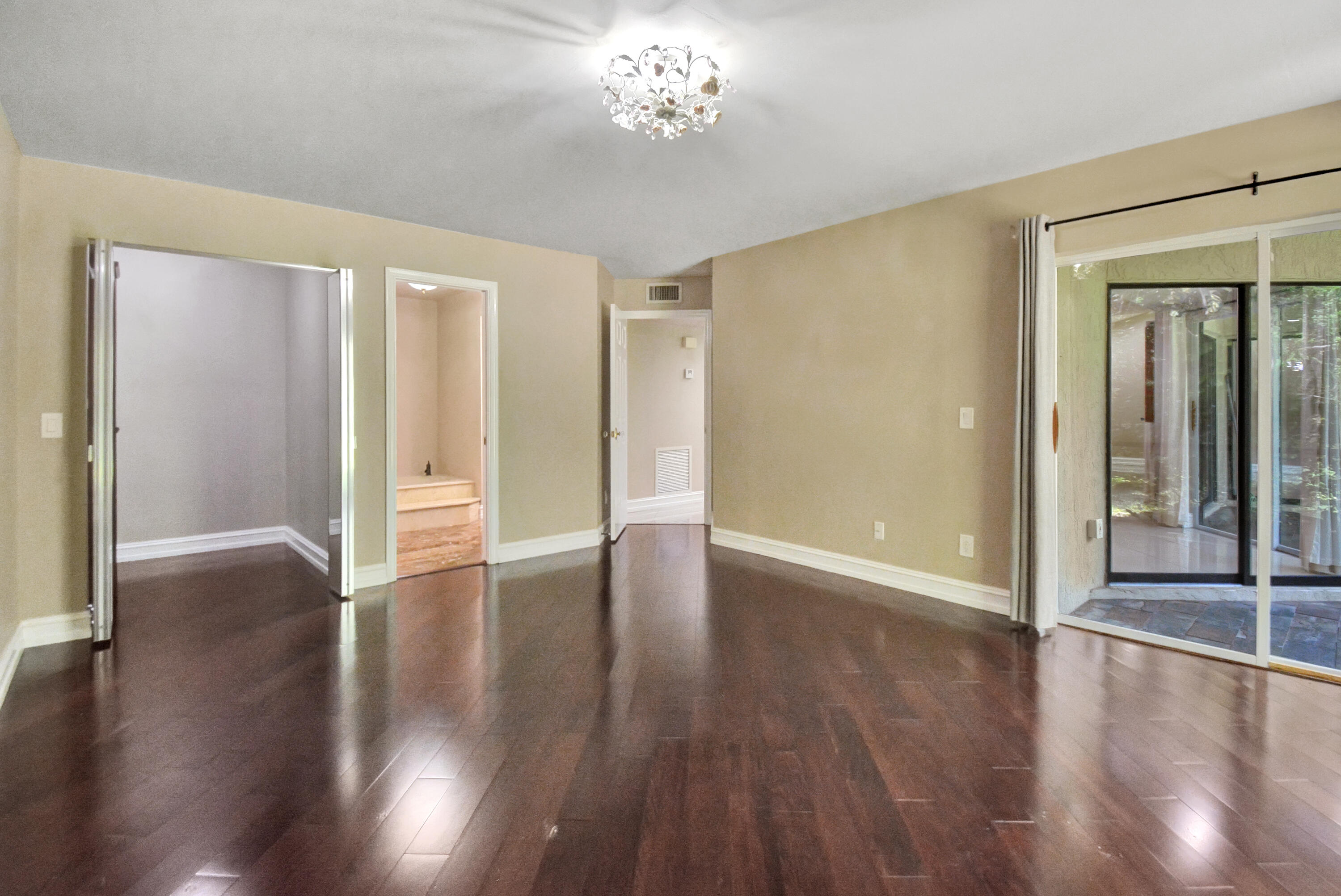 5590 Coach House Circle, Unit A Boca Raton, FL 33486 - Photo 14 of 33 wooden floor in an empty room with a window
