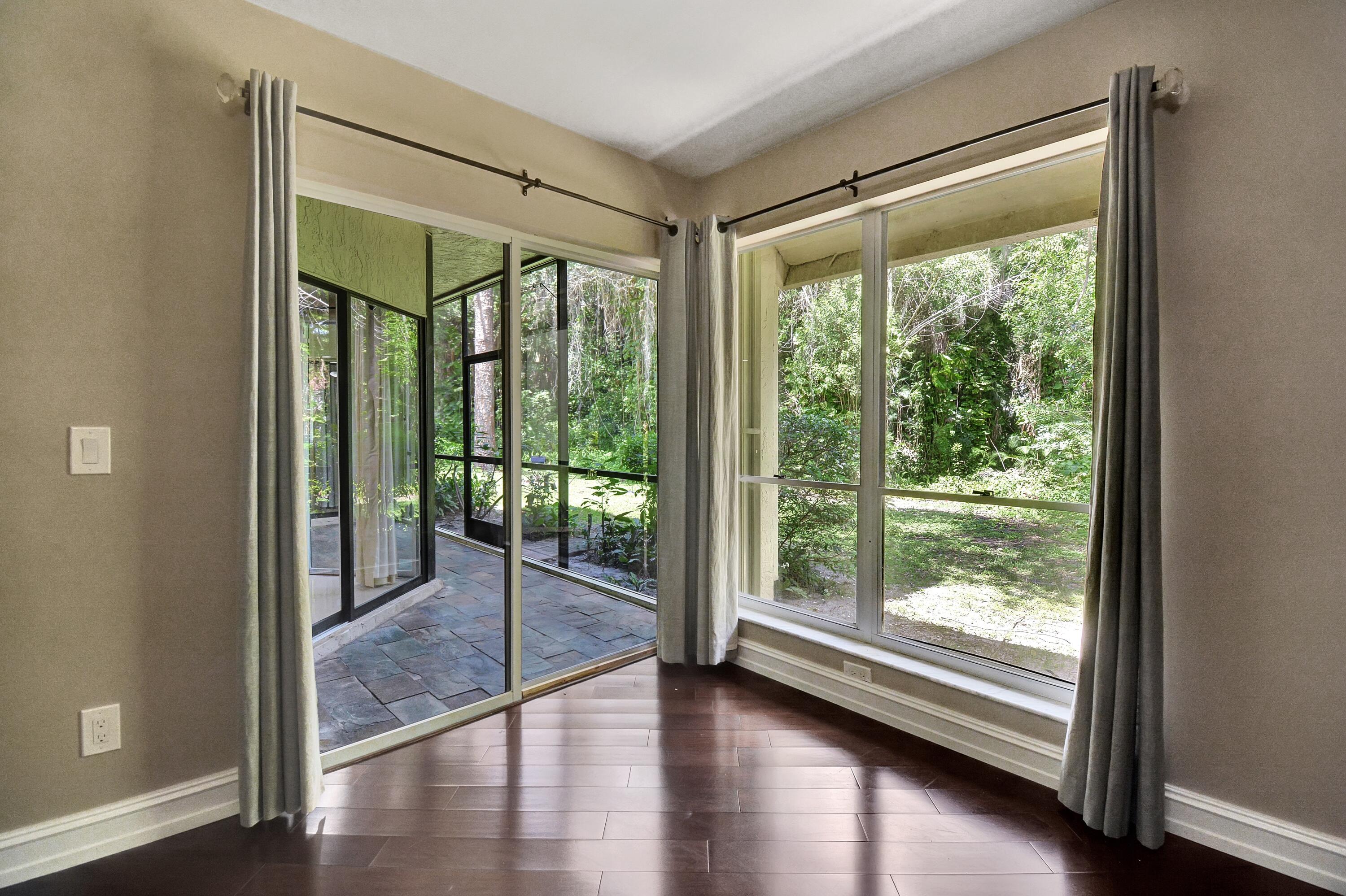 5590 Coach House Circle, Unit A Boca Raton, FL 33486 - Photo 15 of 33 a view of a room with wooden floor and a window
