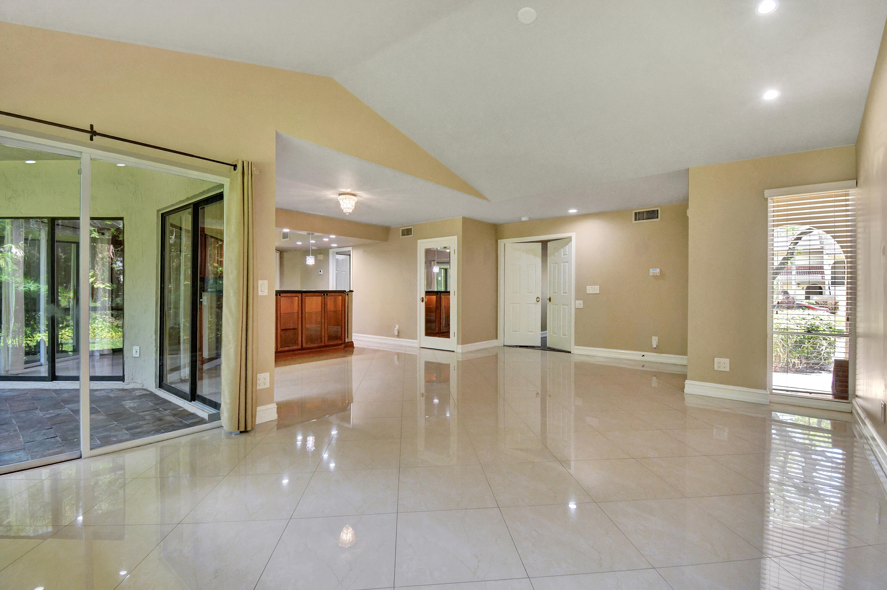 5590 Coach House Circle, Unit A Boca Raton, FL 33486 - Photo 20 of 33 a view of a hallway with wooden floor and a glass door