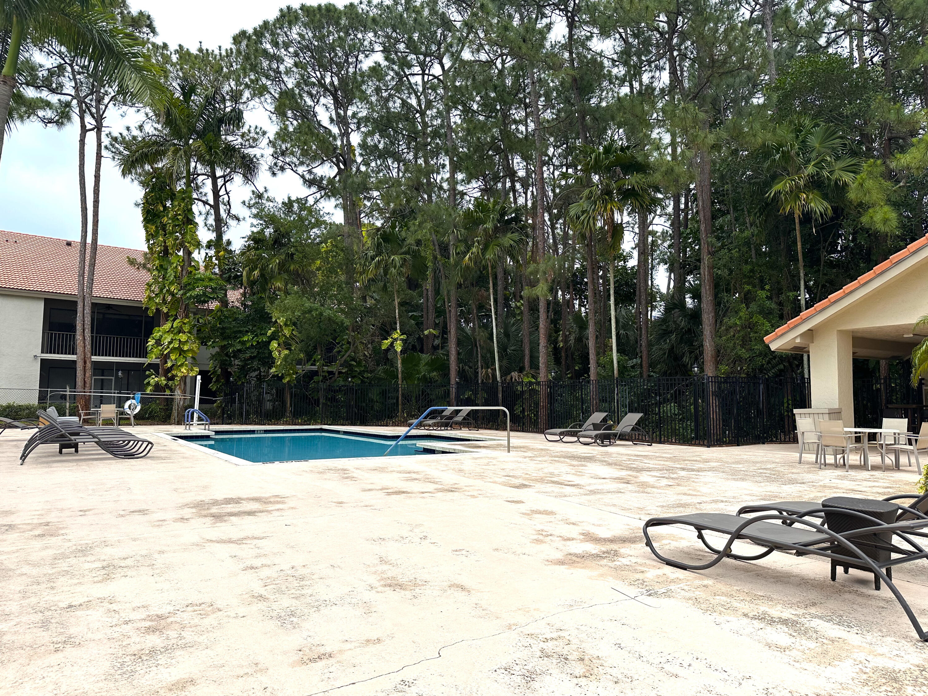 5590 Coach House Circle, Unit A Boca Raton, FL 33486 - Photo 33 of 33 a swimming pool with outdoor seating and yard