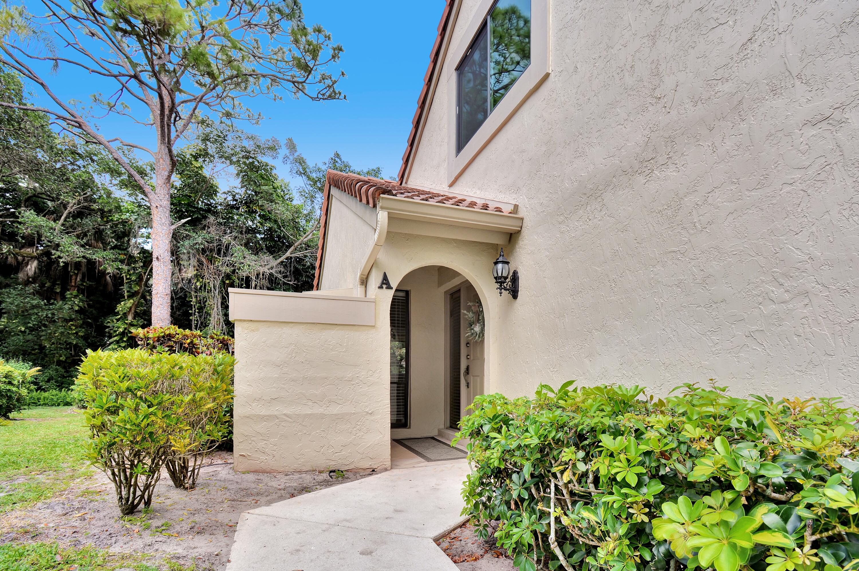 5590 Coach House Circle, Unit A Boca Raton, FL 33486 - Photo 5 of 33 a front view of a house with garden
