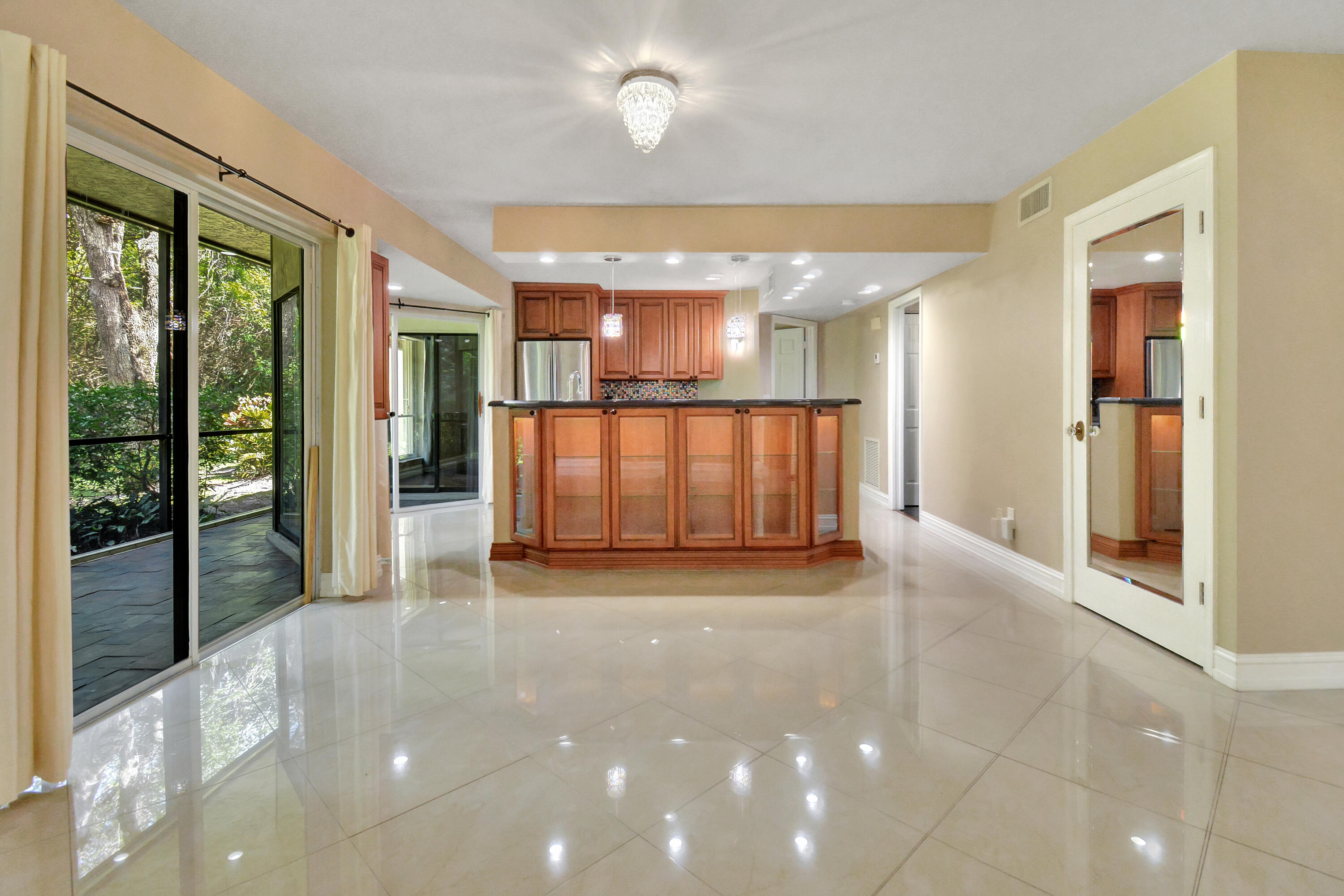 5590 Coach House Circle, Unit A Boca Raton, FL 33486 - Photo 7 of 33 a view of an empty room with glass door