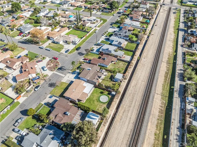 a front view of a house with yard and parking