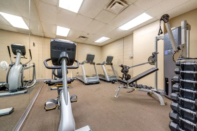 a living room with furniture a rug and a chandelier