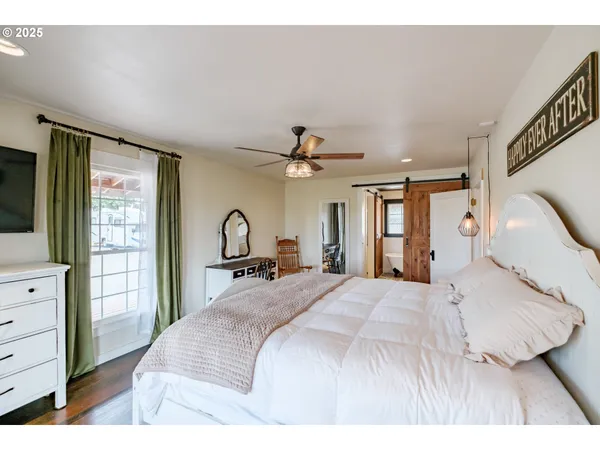 a bedroom with a large bed and a dresser