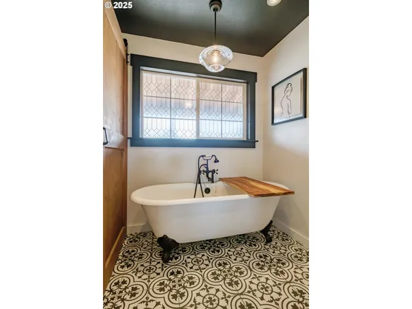 a bathroom with a sink a mirror and a window