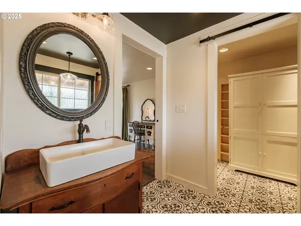 a bathroom with a sink a mirror and a shower