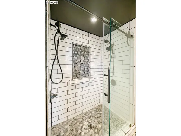 a bathroom with a shower and a glass door