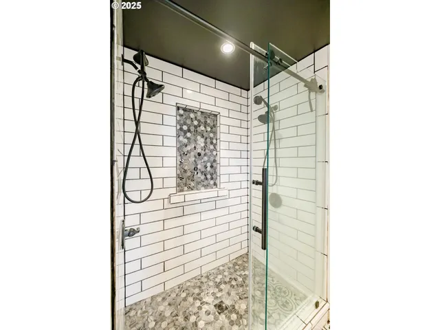 a bathroom with a shower and a glass door