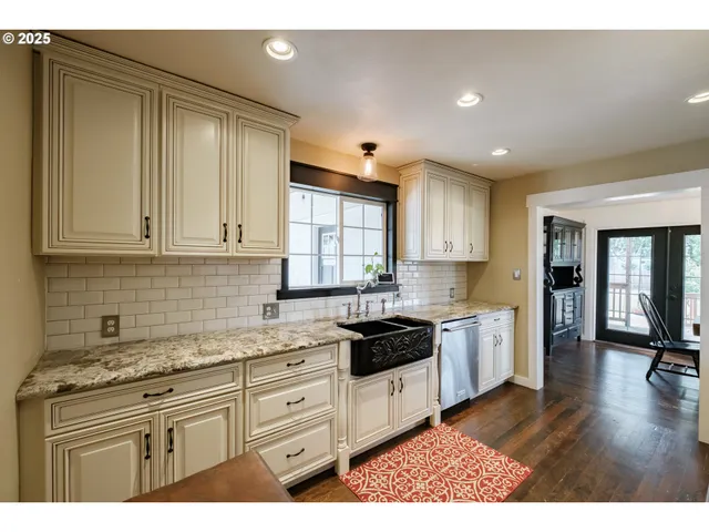 a kitchen with stainless steel appliances granite countertop a stove a sink and a refrigerator